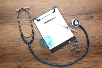 Photo of Flat lay composition of clipboard with word Anesthesia and drugs on wooden table