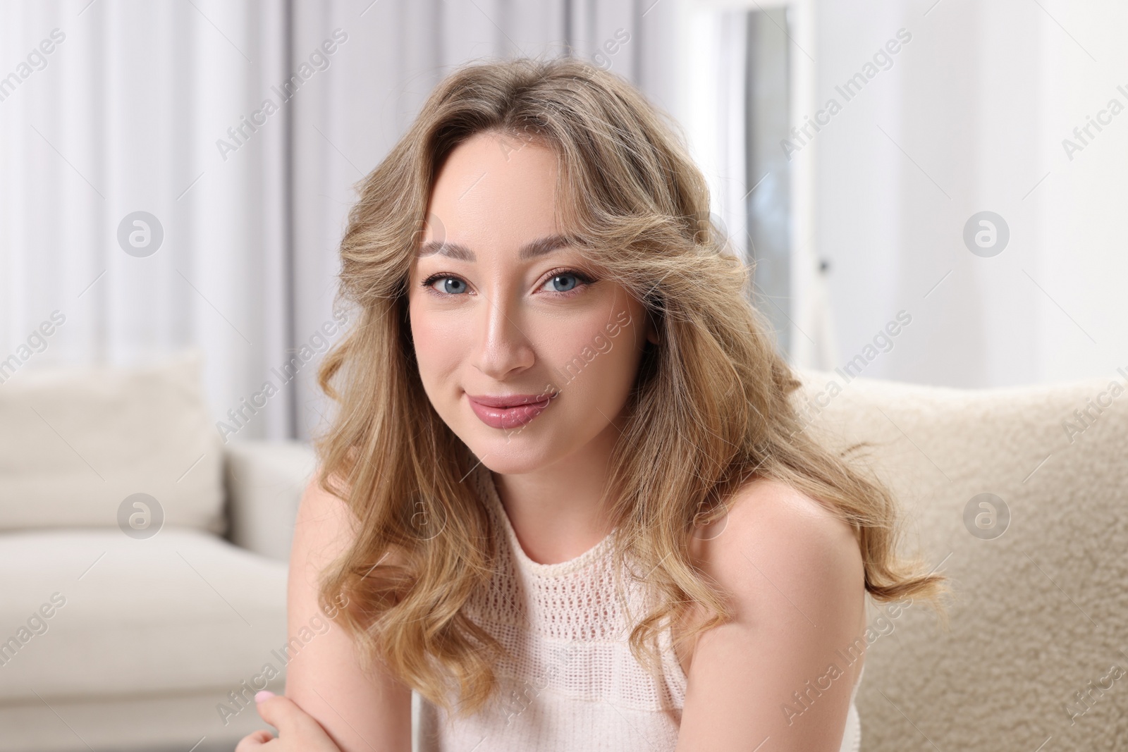 Photo of Portrait of beautiful woman with curly hair at home