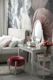 Photo of Stylish bedroom interior with elegant dressing table and floral wallpaper