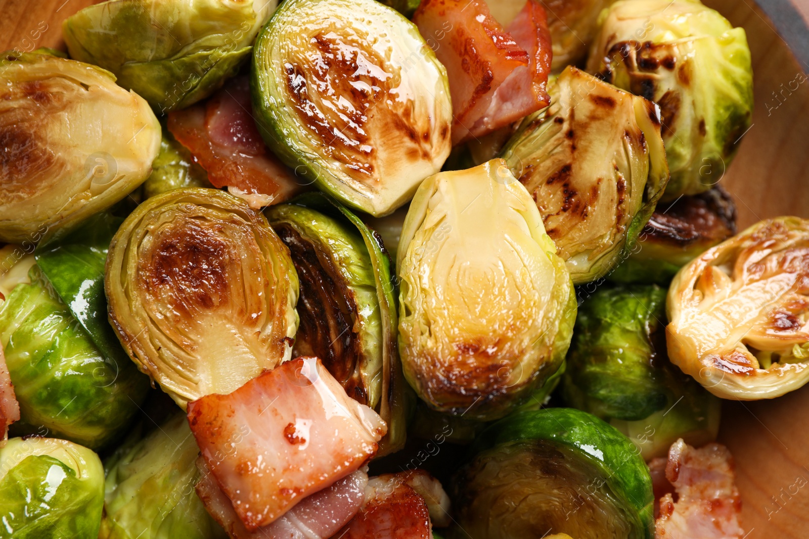 Image of Delicious fried Brussels sprouts with bacon in bowl, closeup