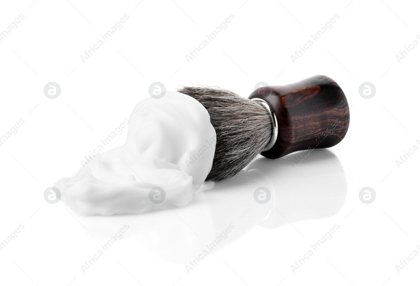 Photo of Shaving foam and brush on white background