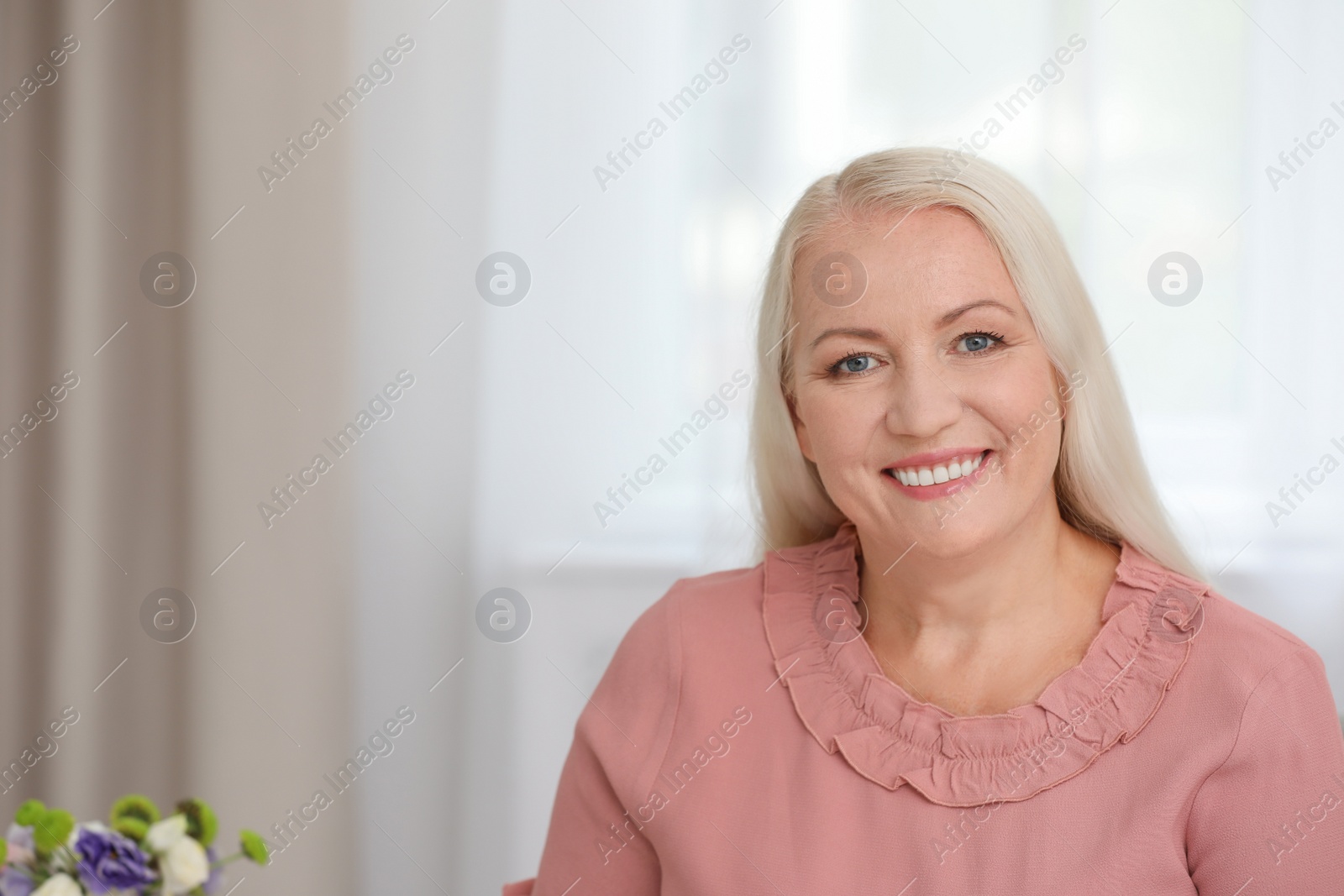 Photo of Portrait of beautiful older woman indoors with space for text