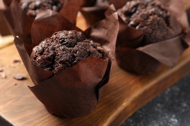 Photo of Tasty chocolate muffins on grey table, closeup