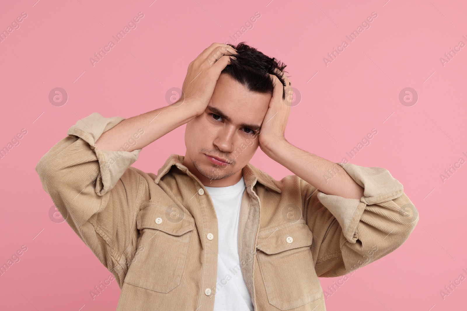Photo of Portrait of resentful man on pink background