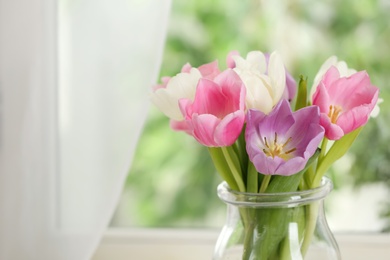 Photo of Beautiful fresh tulips near window indoors. Spring flowers