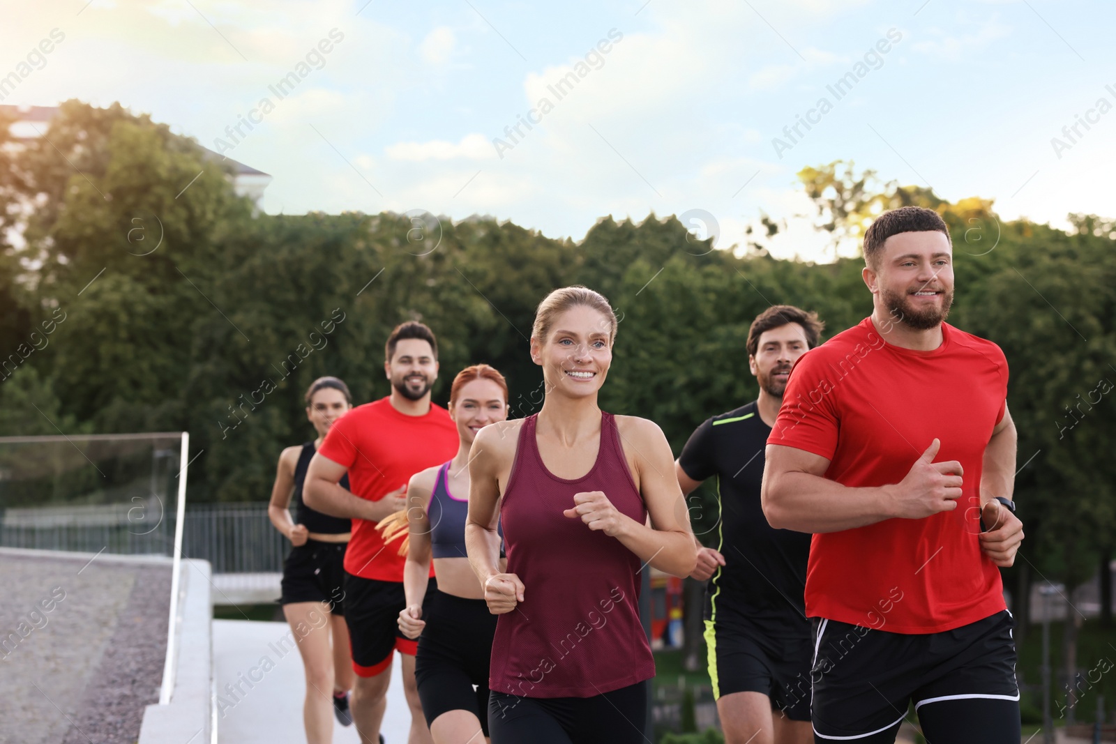 Photo of Group of people running outdoors. Active lifestyle