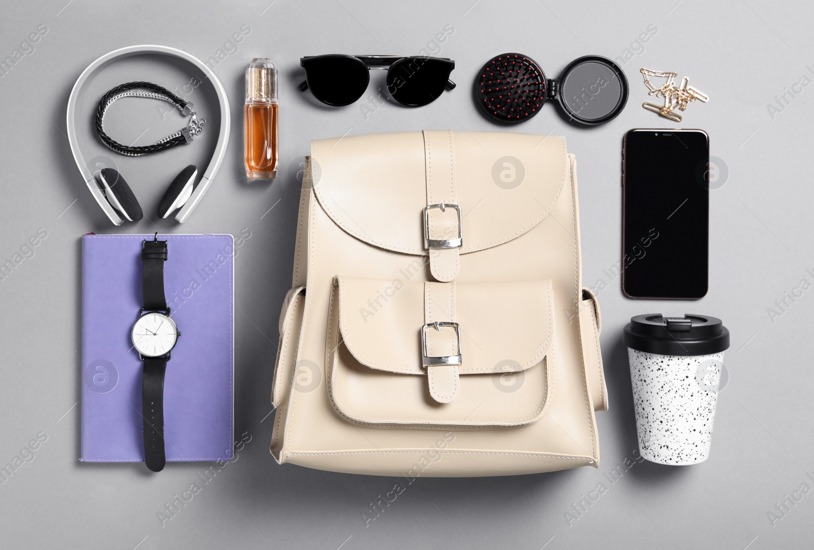 Photo of Stylish urban backpack with different items on grey background, flat lay