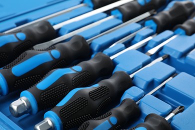 Set of screwdrivers in toolbox as background, closeup