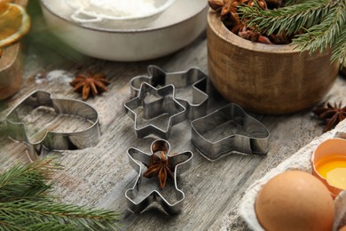 Photo of Cookie cutters on wooden table, closeup. Christmas biscuits
