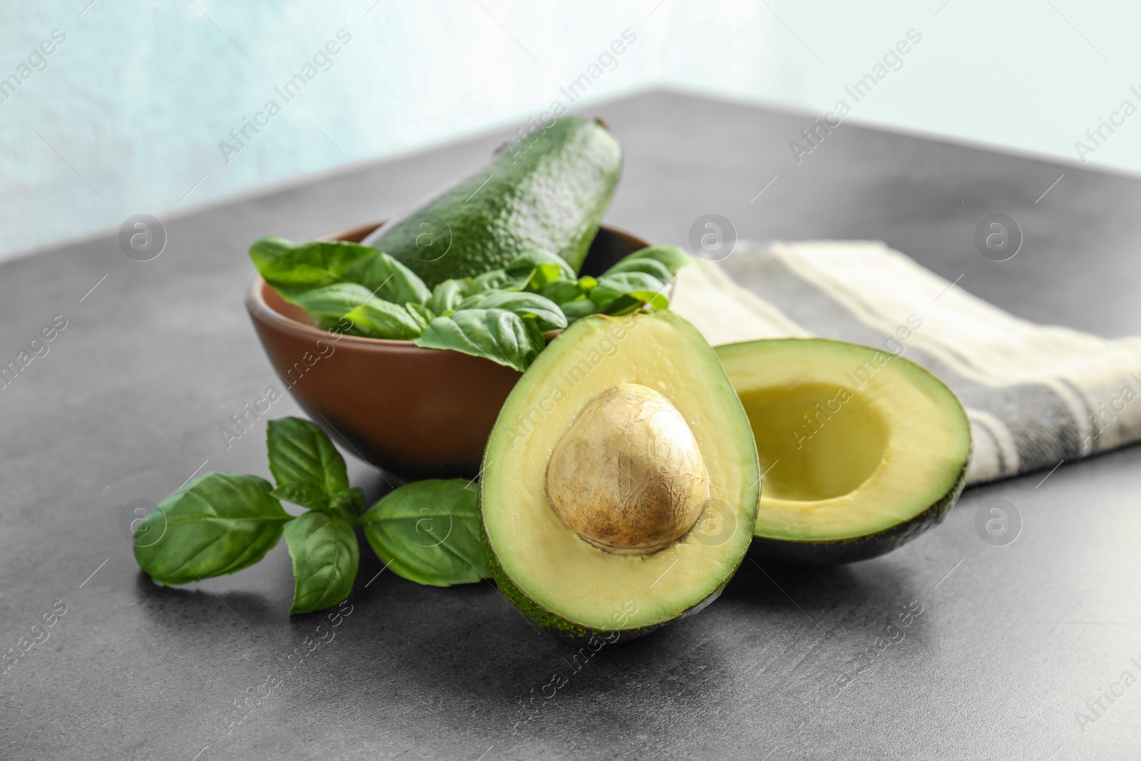 Photo of Composition with ripe avocados and basil on table