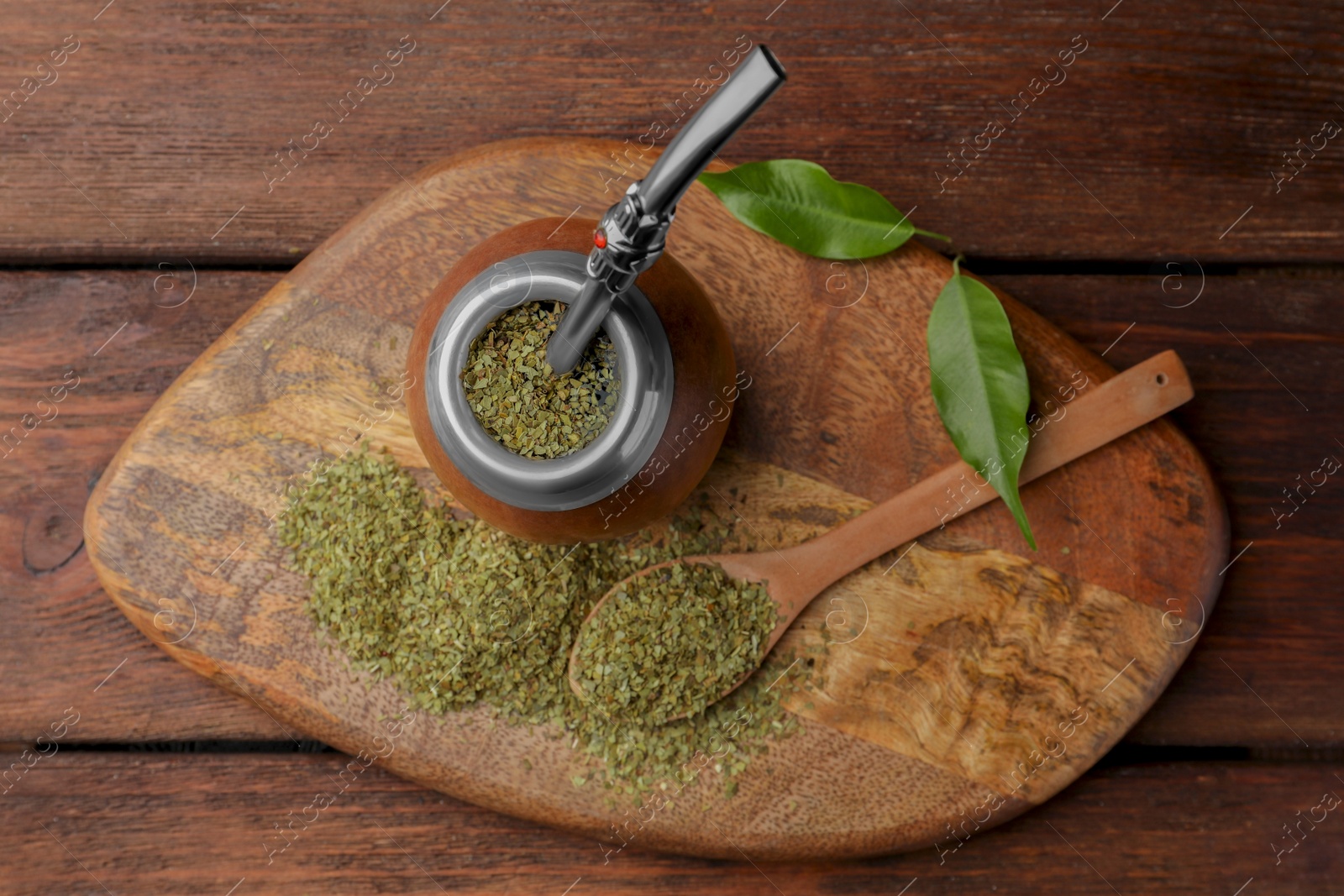 Photo of Calabash with mate tea and bombilla on wooden table, top view