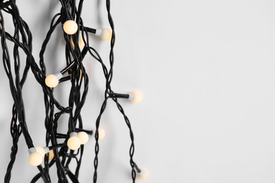 Beautiful Christmas lights on white background, top view