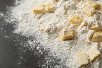 Photo of Making shortcrust pastry. Flour and butter on grey table