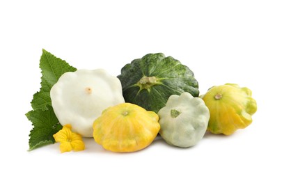 Fresh ripe pattypan squashes with leaves and flower on white background