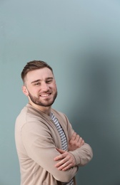 Photo of Portrait of confident young man on color background