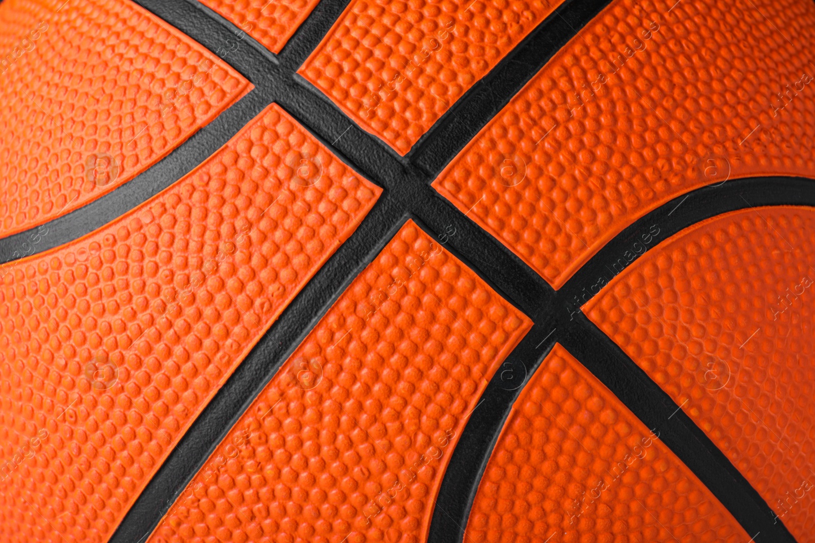 Photo of Orange ball as background, closeup. Basketball equipment