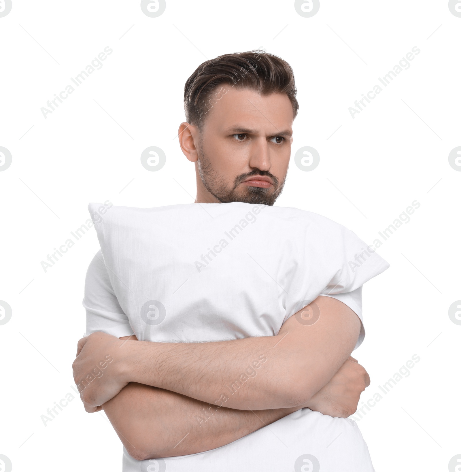 Photo of Unhappy man with pillow on white background. Insomnia problem