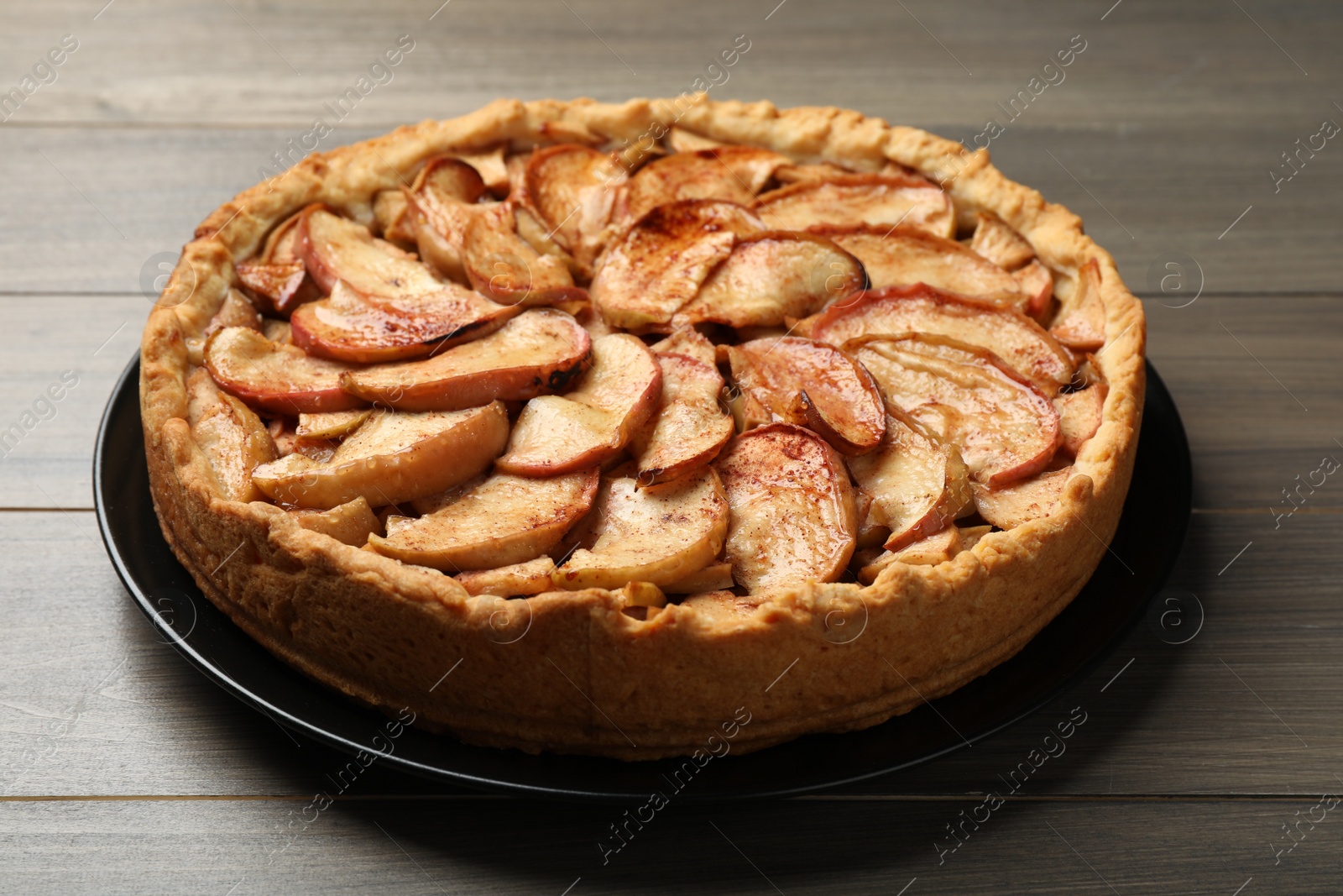 Photo of Fresh delicious apple pie on wooden table