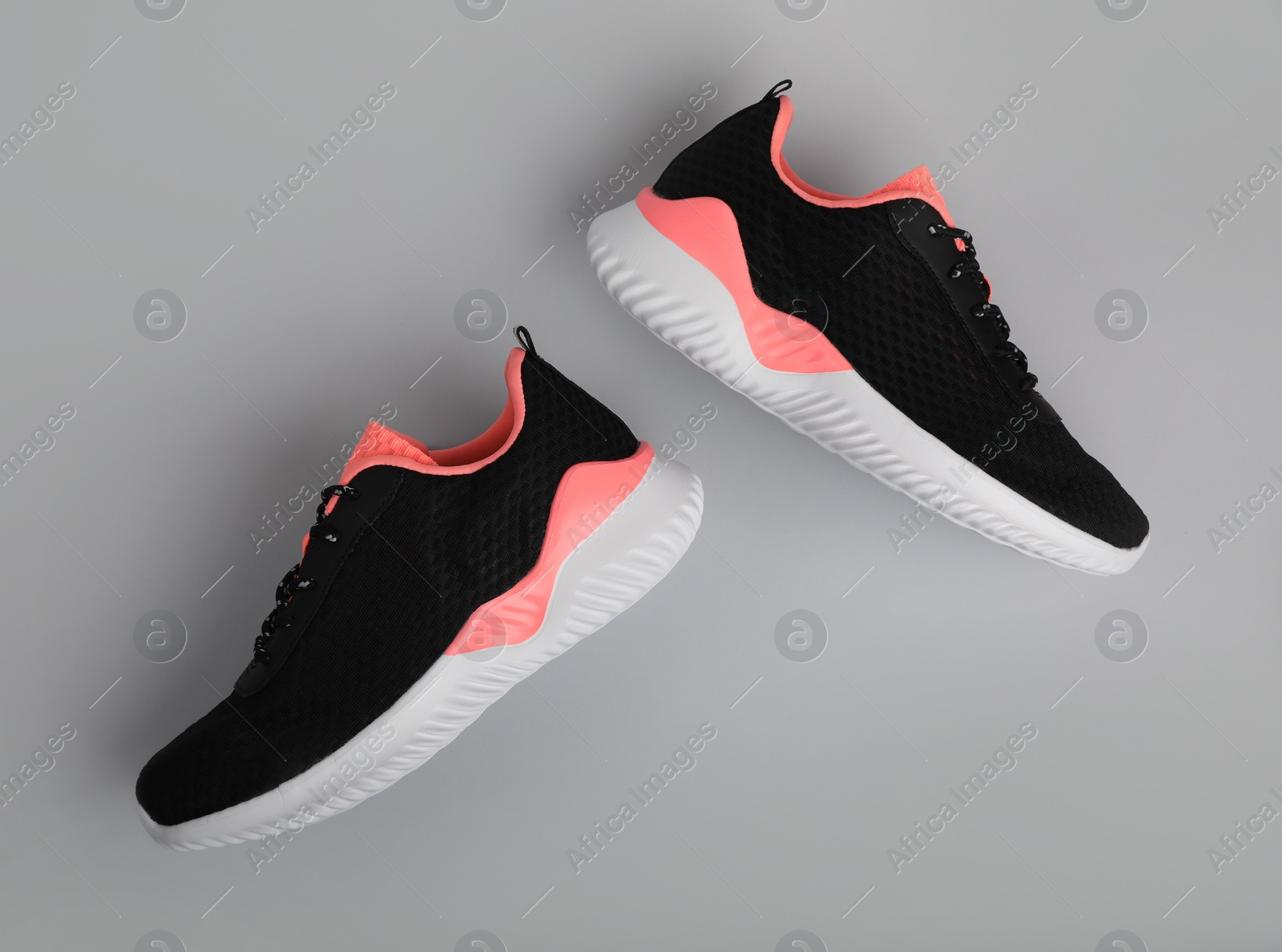 Photo of Pair of comfortable sports shoes on grey background, flat lay