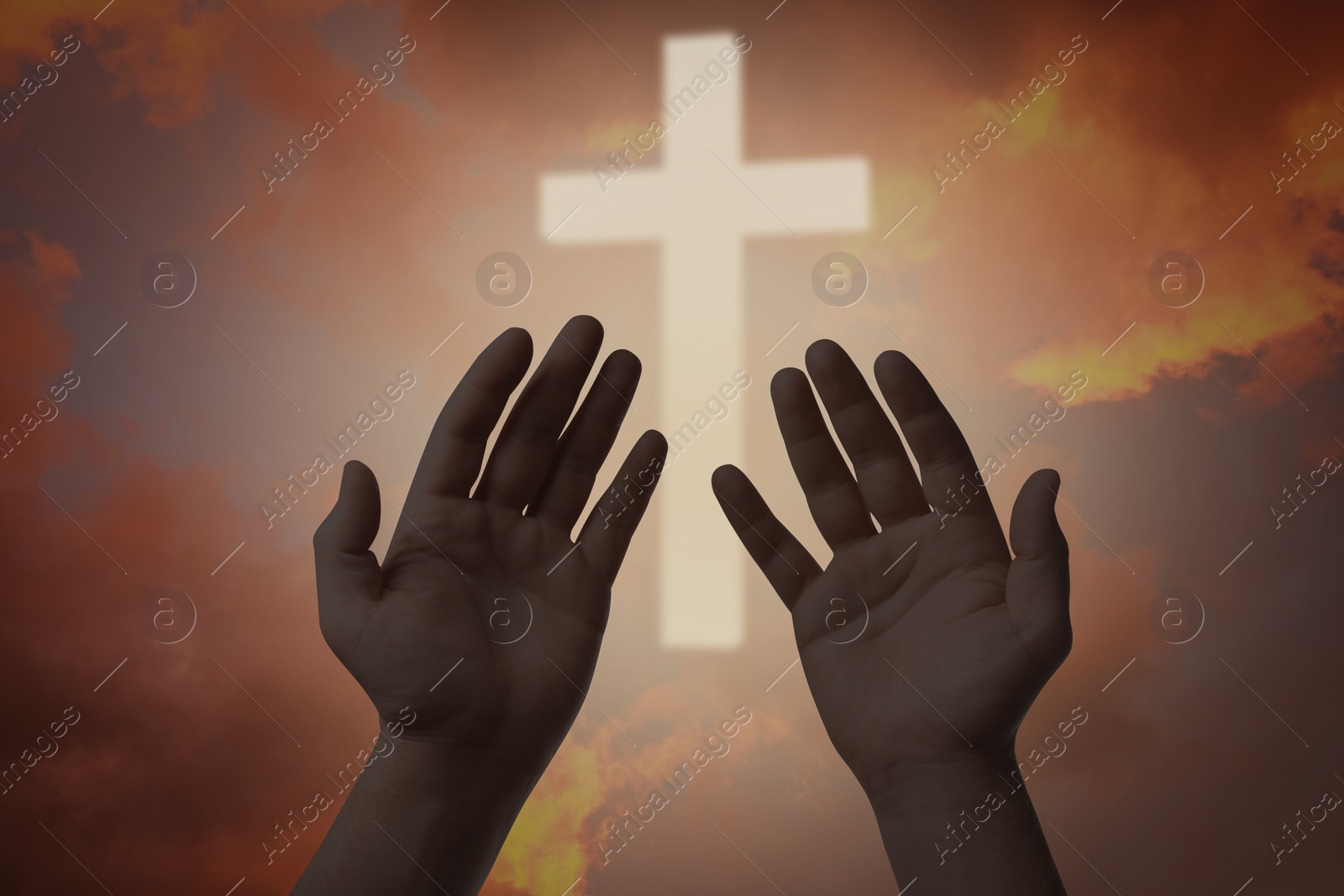 Image of Religion. Christian man praying against sky with glowing cross, closeup