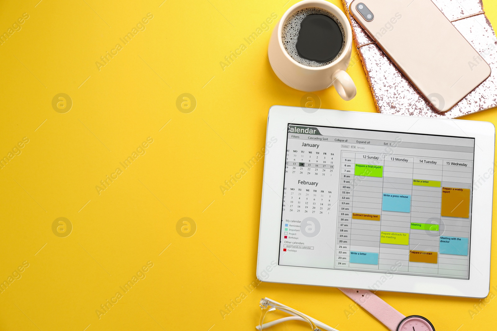 Photo of Modern tablet with calendar app on yellow background. Space of text