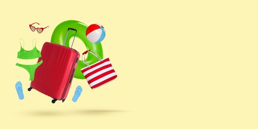 Image of Red suitcase and beach accessories flying on beige background. Banner design with space for text