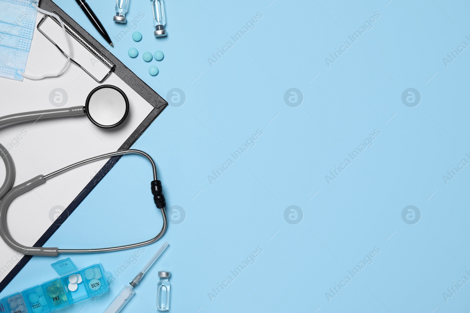 Photo of Flat lay composition with medical objects on light blue background, space for text