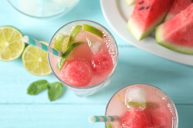 Photo of Delicious refreshing watermelon drink on blue wooden table, top view