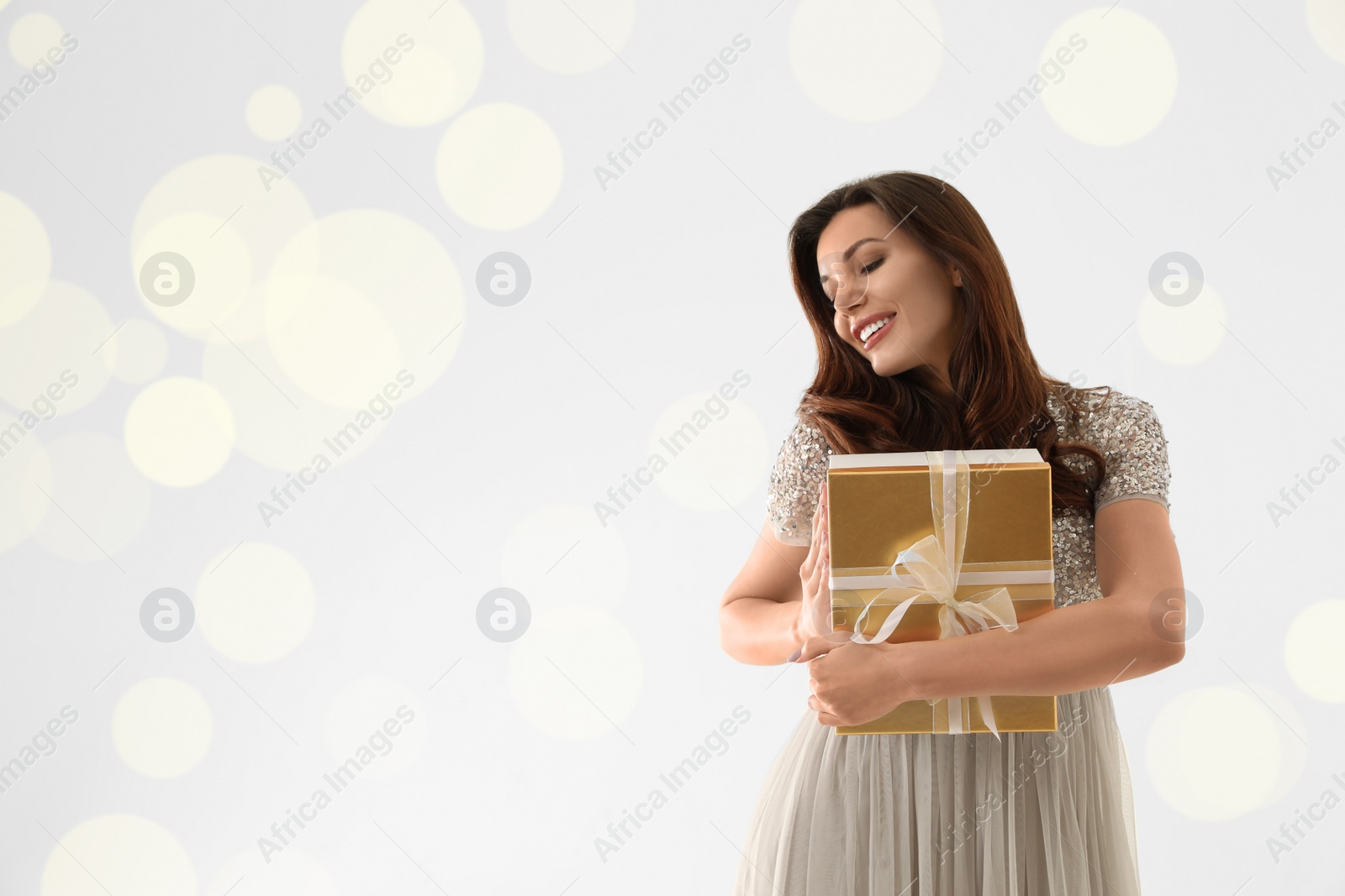 Photo of Beautiful woman with Christmas gift on white background