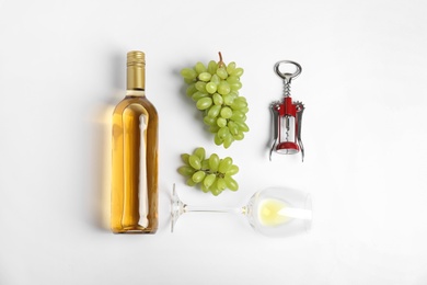 Composition with wine and grape on white background, top view