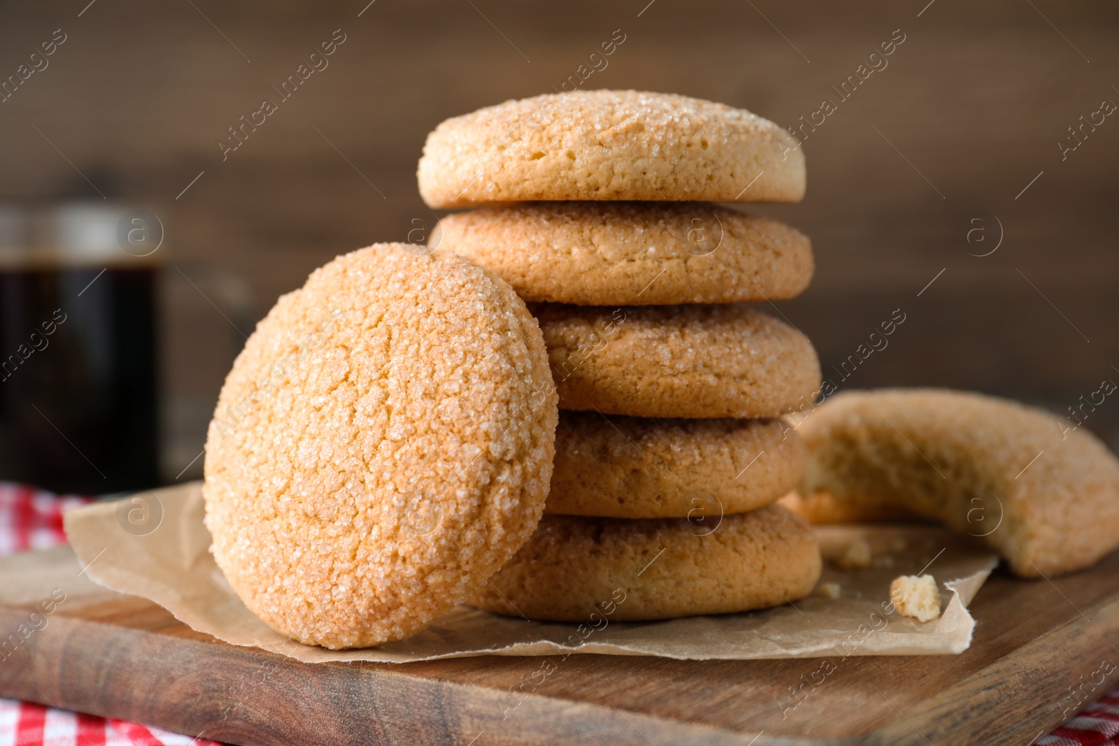 Photo of Delicious sugar cookies on wooden board, closeup