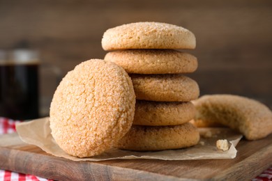 Photo of Delicious sugar cookies on wooden board, closeup