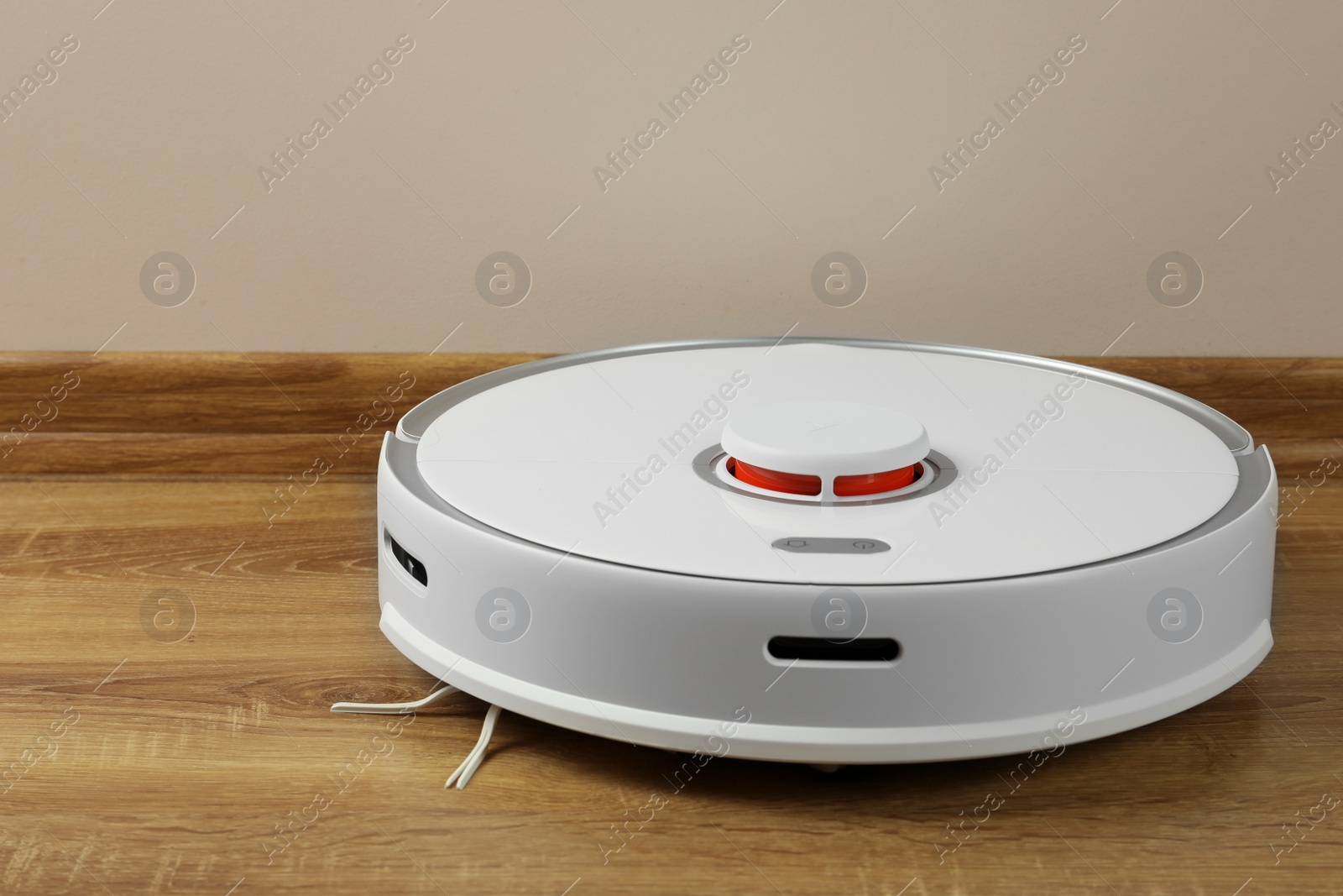 Photo of Robotic vacuum cleaner on wooden floor indoors