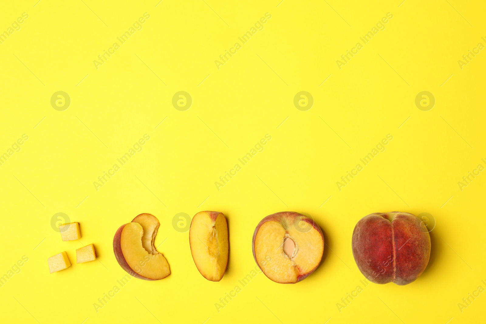 Photo of Flat lay composition with ripe peaches on yellow background, space for text