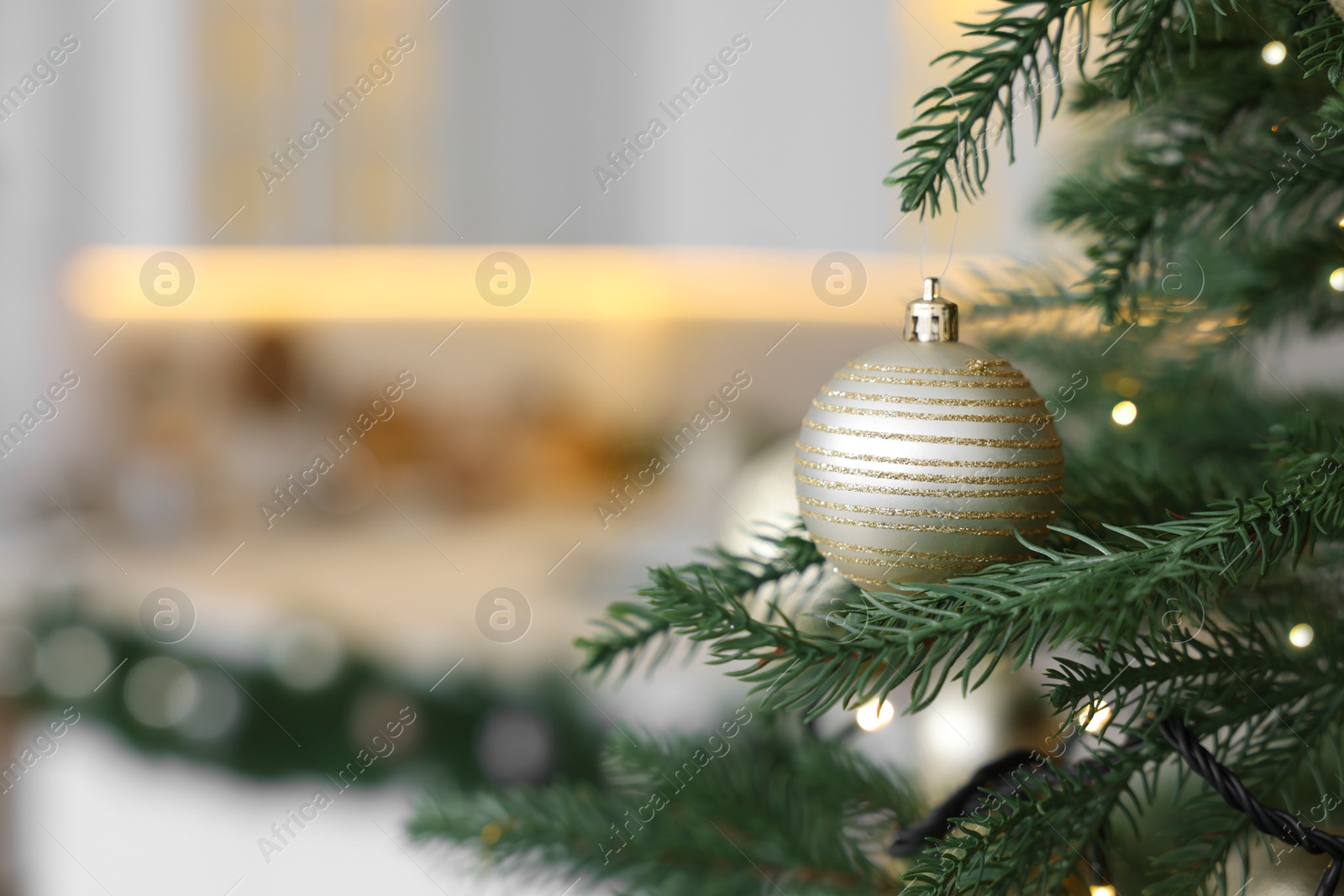 Photo of Closeup view of beautiful decorated Christmas tree in kitchen. Space for text