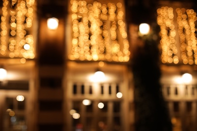 Photo of Blurred view of building with beautiful street lights at night. Bokeh effect