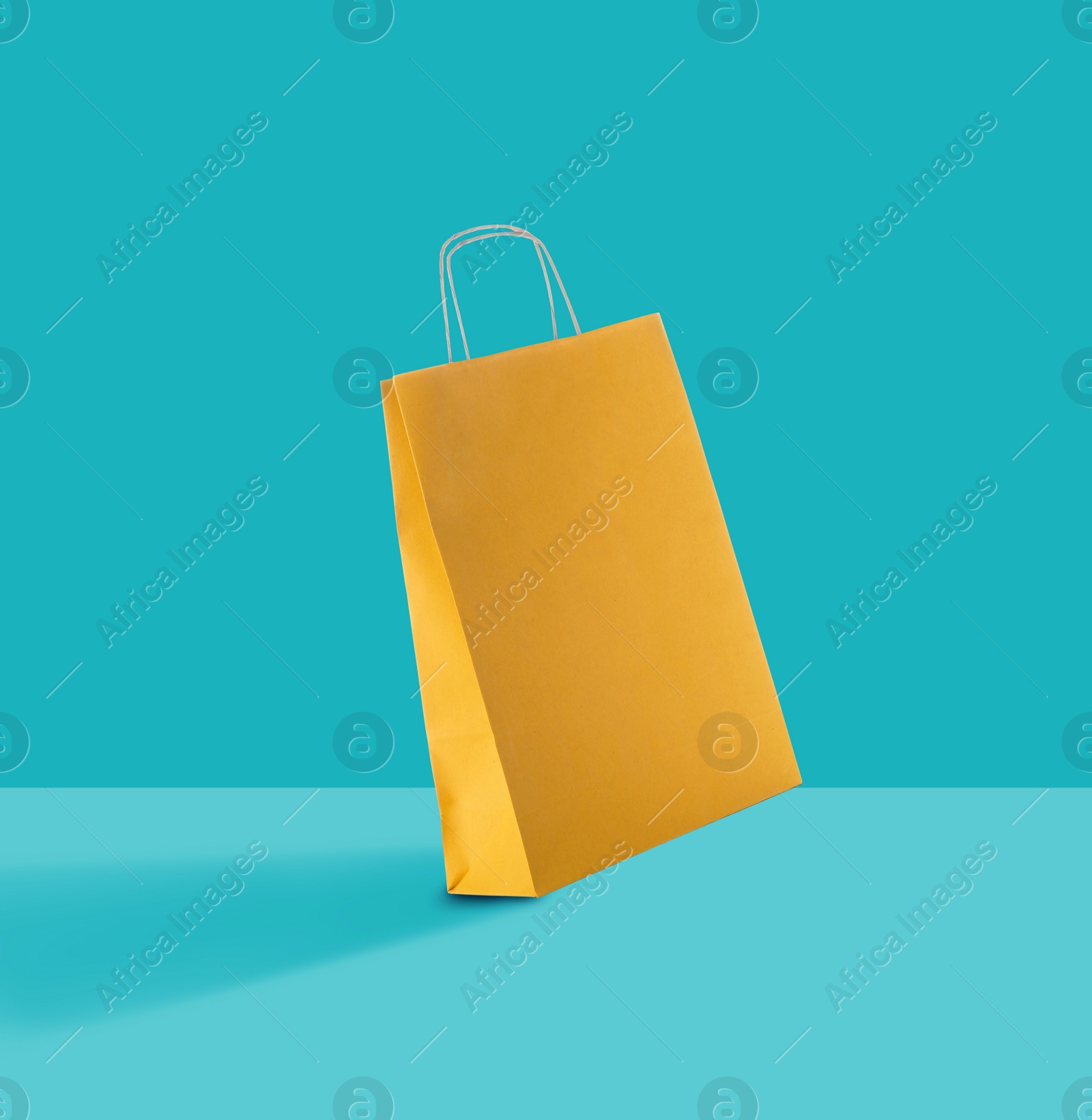 Image of Yellow paper bag on color background. Mockup for design