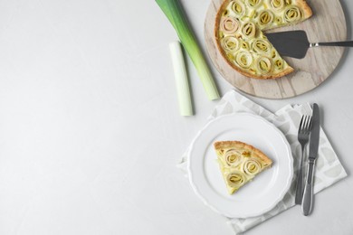 Tasty leek pie served on white table, flat lay. Space for text
