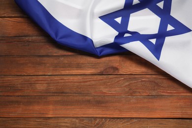 Photo of Flag of Israel on wooden background, above view and space for text. National symbol