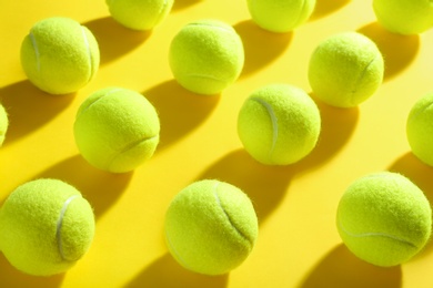 Tennis balls on yellow background. Sports equipment