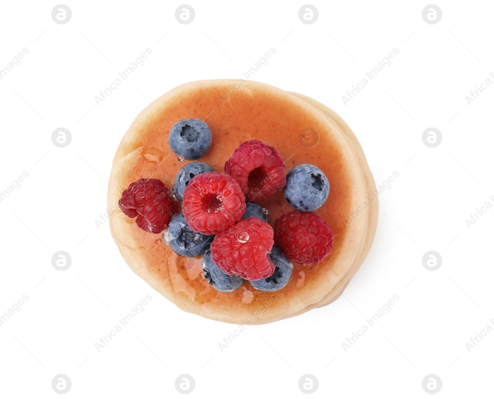 Photo of Delicious pancake with berries and honey isolated on white, top view