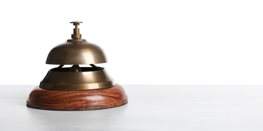 Photo of Hotel service bell on wooden table against white background