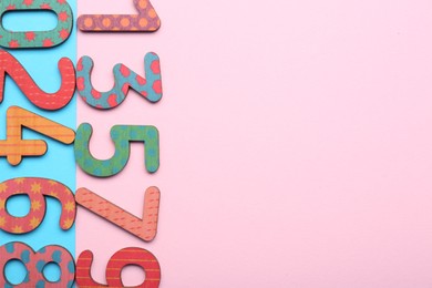 Photo of Wooden numbers on colorful background, flat lay. Space for text