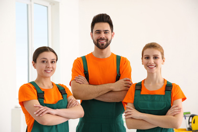 Photo of Team of professional janitors indoors. Cleaning service