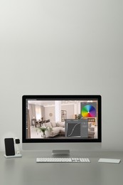 Image of Designer's workplace. Computer with photo editor application on table