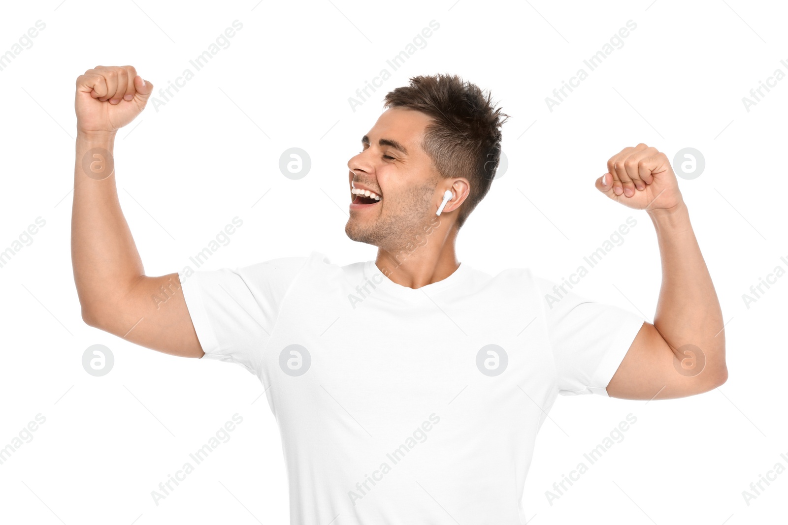 Photo of Happy young man listening to music through wireless earphones on white background