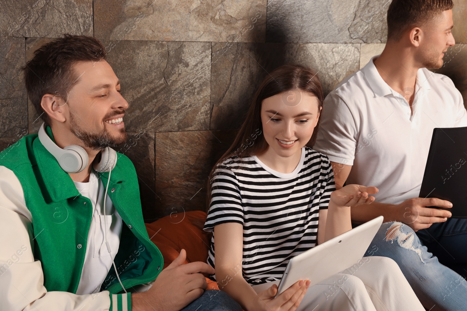 Photo of Office employees enjoying break together in recreation room at work