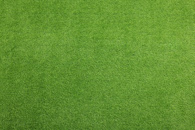 Photo of Green artificial grass as background, top view