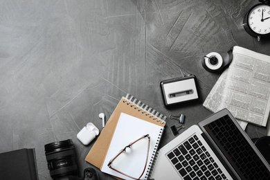 Flat lay composition with equipment for journalist on grey table, space for text