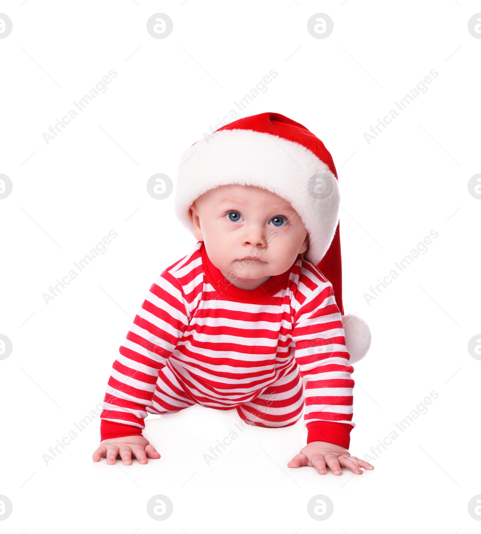 Photo of Cute baby in Santa hat and bright Christmas pajamas on white background